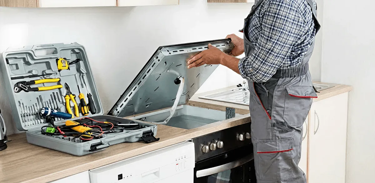 Handyman repairing a cooktop and checking wiring connections in Sarasota, FL