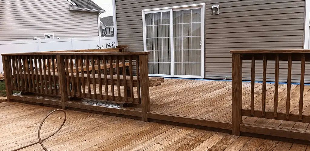 Deck sealing service protecting a backyard wood deck and railings in Sarasota, FL