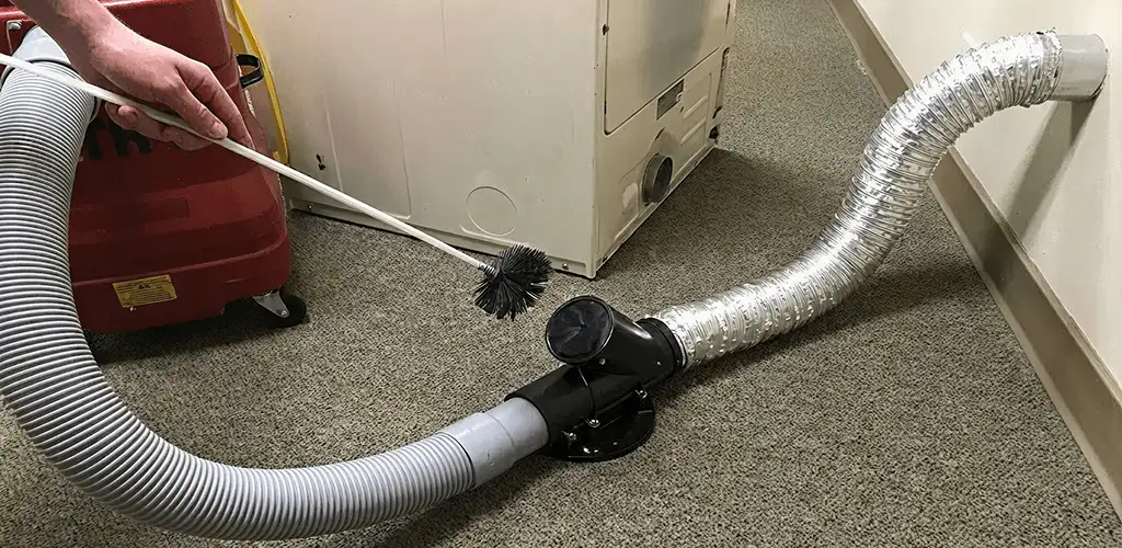 Dryer vent cleaning service removing lint from a dryer duct connection in Sarasota, FL