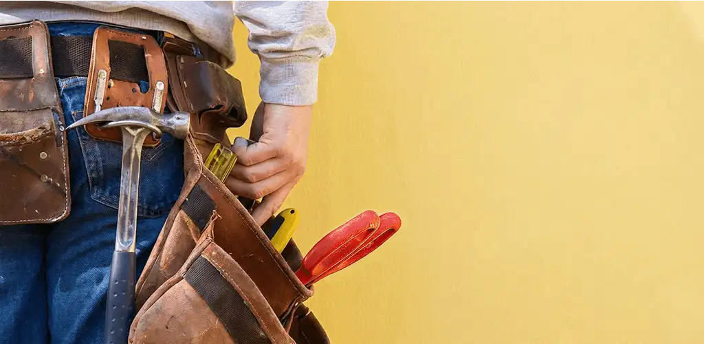 Handyman with tool belt ready for home repairs and maintenance in Sarasota, FL