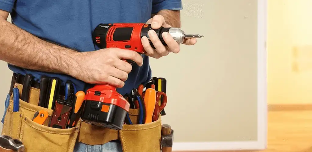 Handyman holding a power drill for home repairs and installations in Sarasota, FL