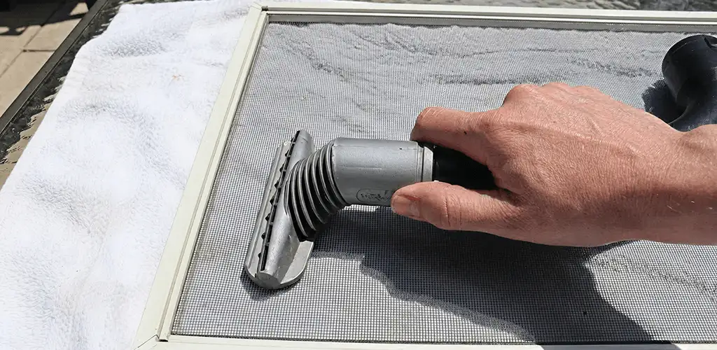 Window screen repair cleaning and fixing a damaged screen mesh in Sarasota, FL