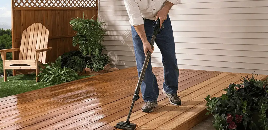 Deck staining service applying stain to a backyard wood deck in Sarasota, FL